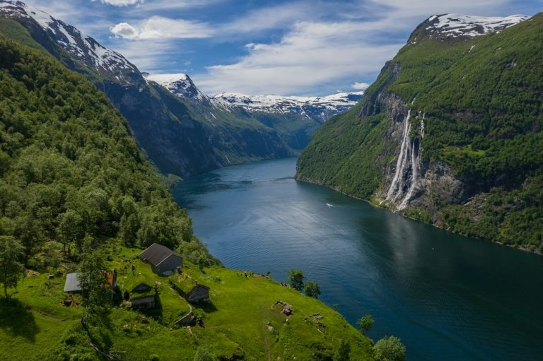 Norwegian fjord surrounded by steep green mountains